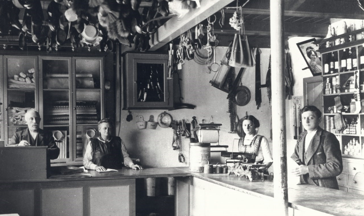Olsen-brødrenes forfædre arbejdede i denne butik. Fra venstre: Knud Madsen, Dorthea Madsen, Karen Marie Olsen (brødrenes bedstemor) og Jens Magnus Madsen. Foto taget i 1916.